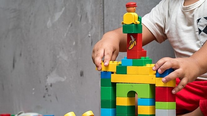Child playing with a toy building set